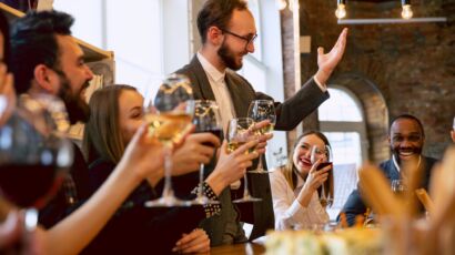 Guests raising wine glasses at a holiday dinner table catered in Miami